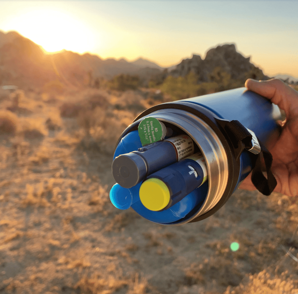 4AlLFamily Explorer Insulin Cooler Picture taken in the desert showing 2 insulin pens